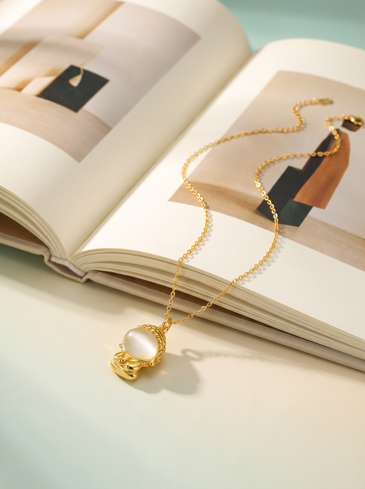 Gold necklace resting on an open book
