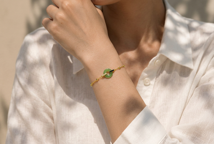Gold bracelet with a green stone